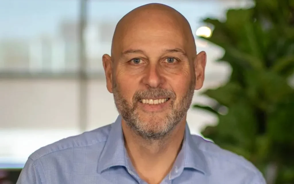 As income nears £1 billion, OCU main Hughes points to global markets.
